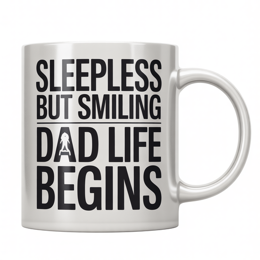 Front view of a white ceramic coffee mug with 'Sleepless But Smiling - Dad Life Begins' text, ideal gift for new dads.